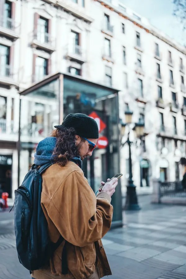 Traveler using a smartphone on a European city street