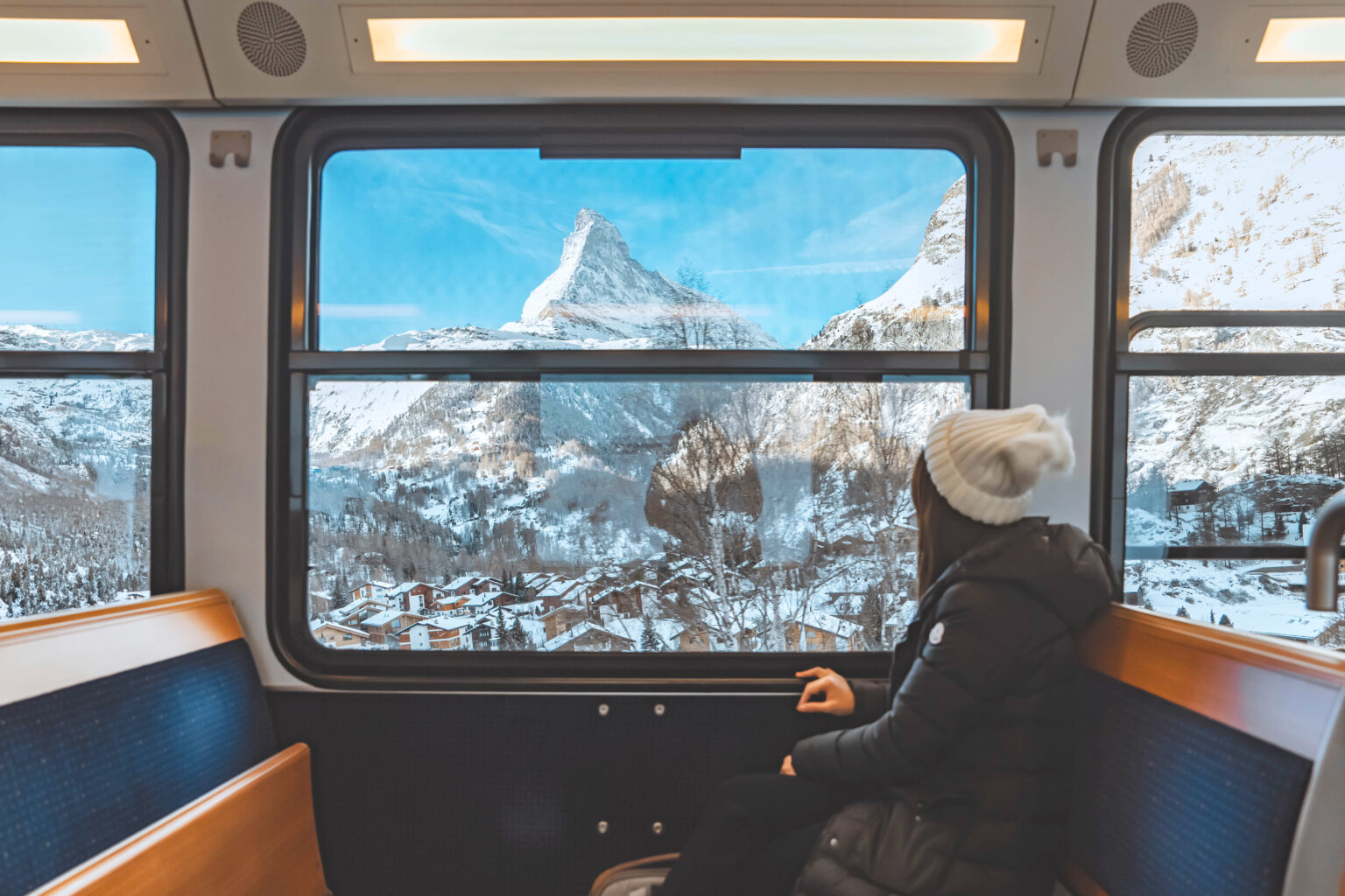 A scenic European rail journey through green mountains
